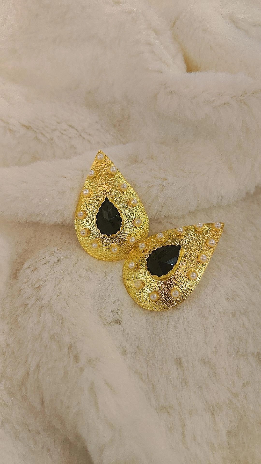 gold with black and white stone earring